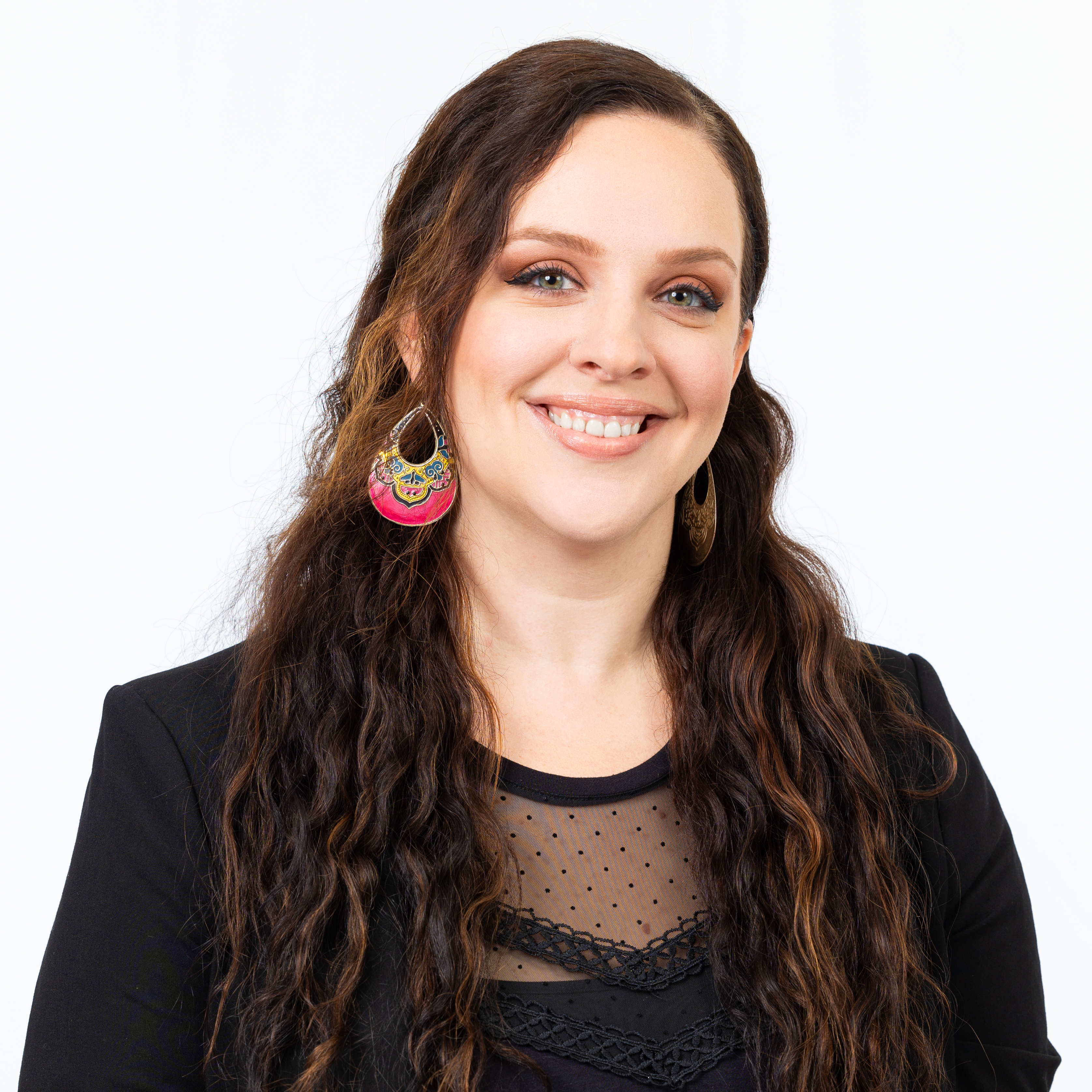 Pamela Nigh, Assistant Director – Partnerships & Pathways, wearing a black blazer and long wavy hair, smiling against a light background.